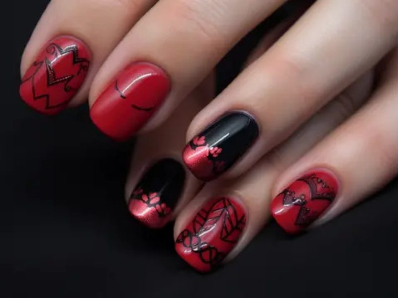 pngtree-two-women-have-red-and-black-nails-with-designs-image_2698351